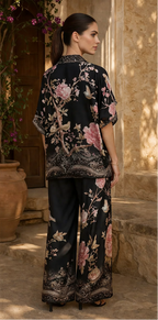 Woman wearing a black floral outfit in an outdoor setting