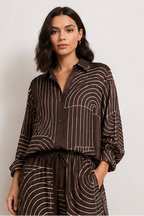 A model is shown in a four-panel collage wearing a dark brown and beige striped matching set consisting of a long-sleeve button-up shirt and wide-leg trousers. The set features a wavy, concentric stripe pattern.